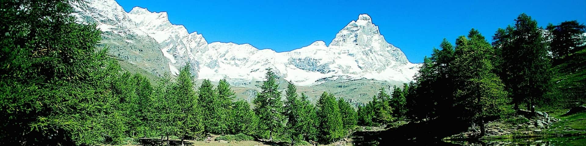 Valtournenche featuring snow, a lake or waterhole and mountains