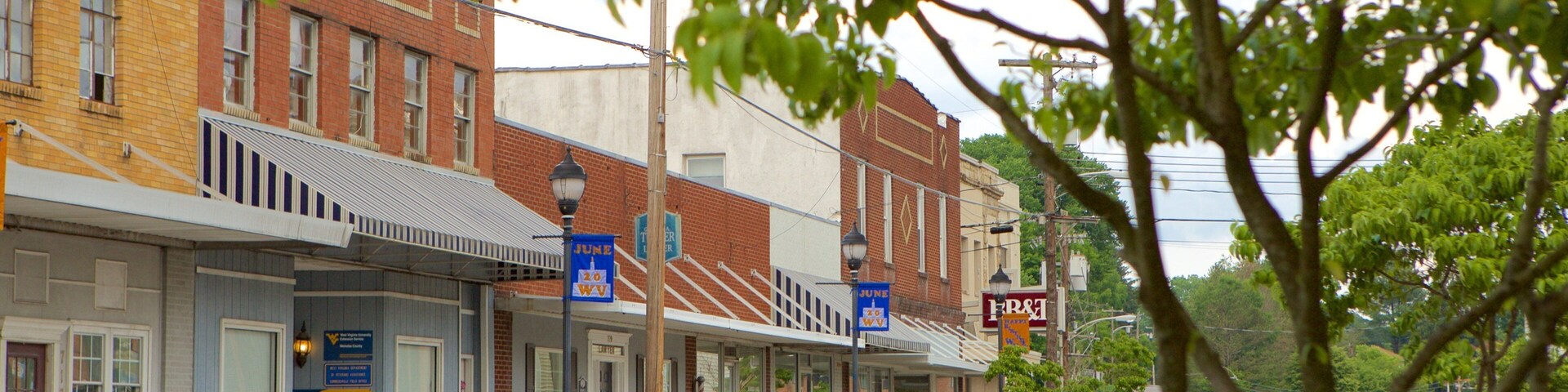 Summersville which includes a small town or village, street scenes and heritage elements