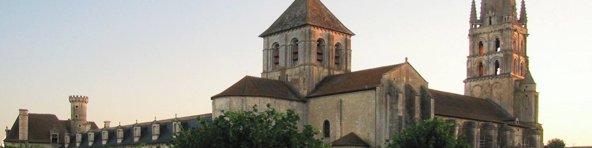 A historic church with a prominent spire and a smaller adjacent building.