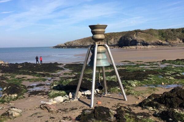 Tidal bell. The incoming tide rings the bronze bell.