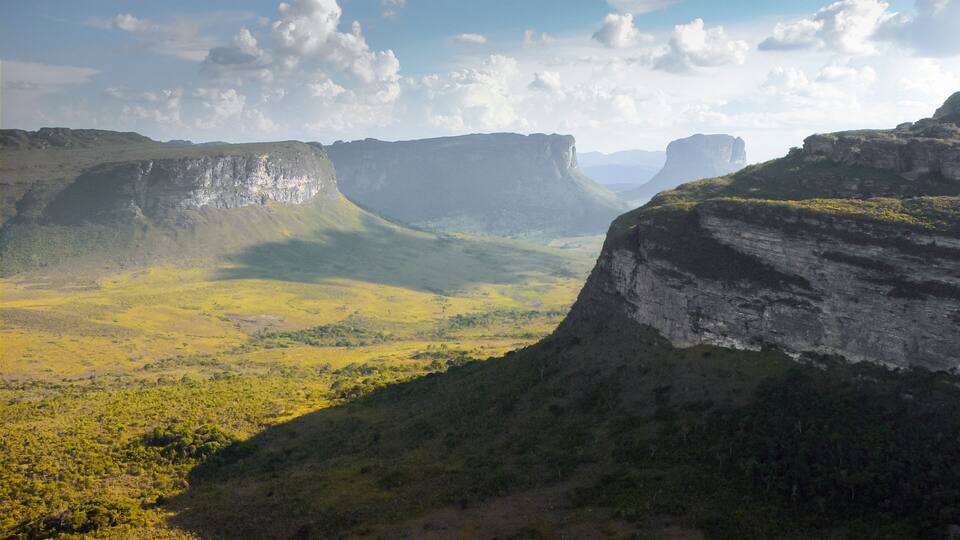 A mountainous landscape with a valley and cliffs.