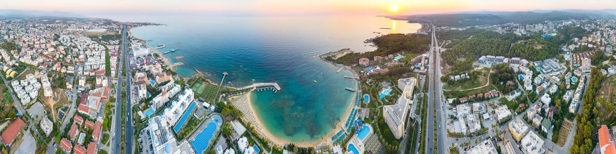 Avsallar, Alanya, Turkey. Cylindrical sunset panorama over D400 highway, panoramic views of coastal town, resort hotels, sandy beaches and Mediterranean bay. Panorama 360. Aerial view