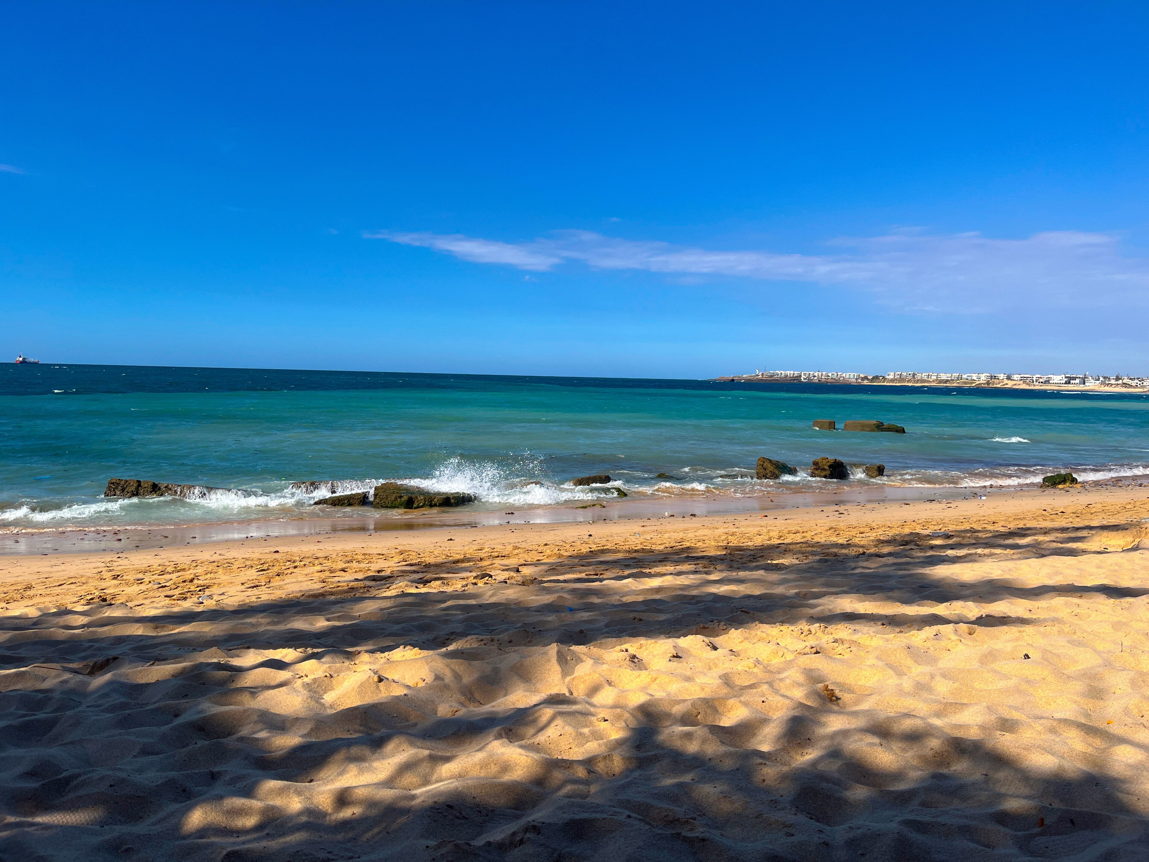 Gentle waves crashing on a tropical beach in Mohammedia, Morocco