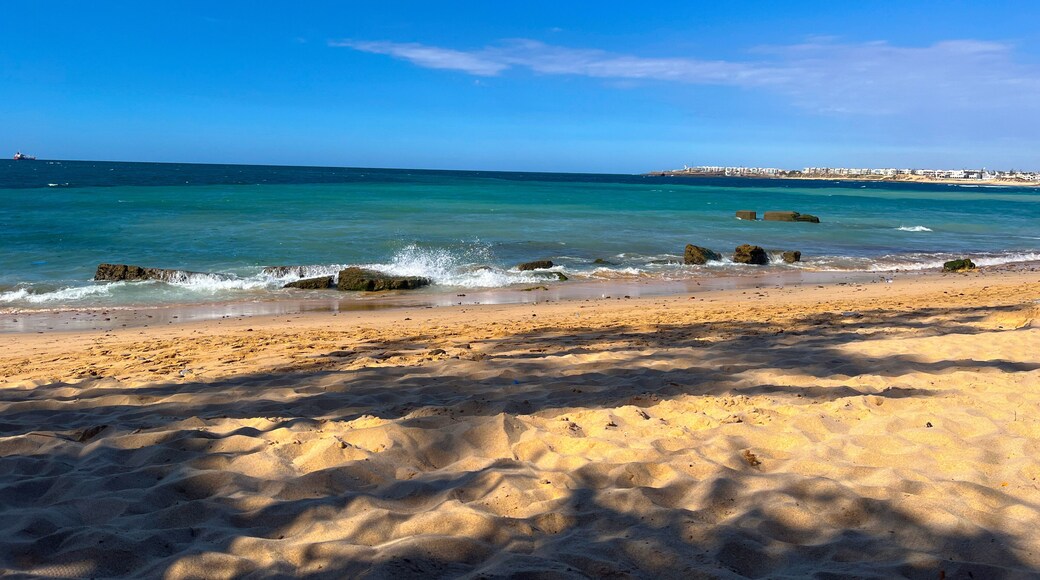 Gentle waves crashing on a tropical beach in Mohammedia, Morocco