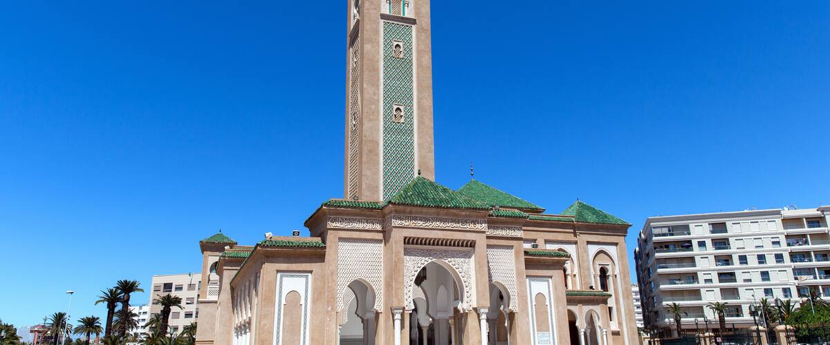 A tall tower with intricate tile work and arches.