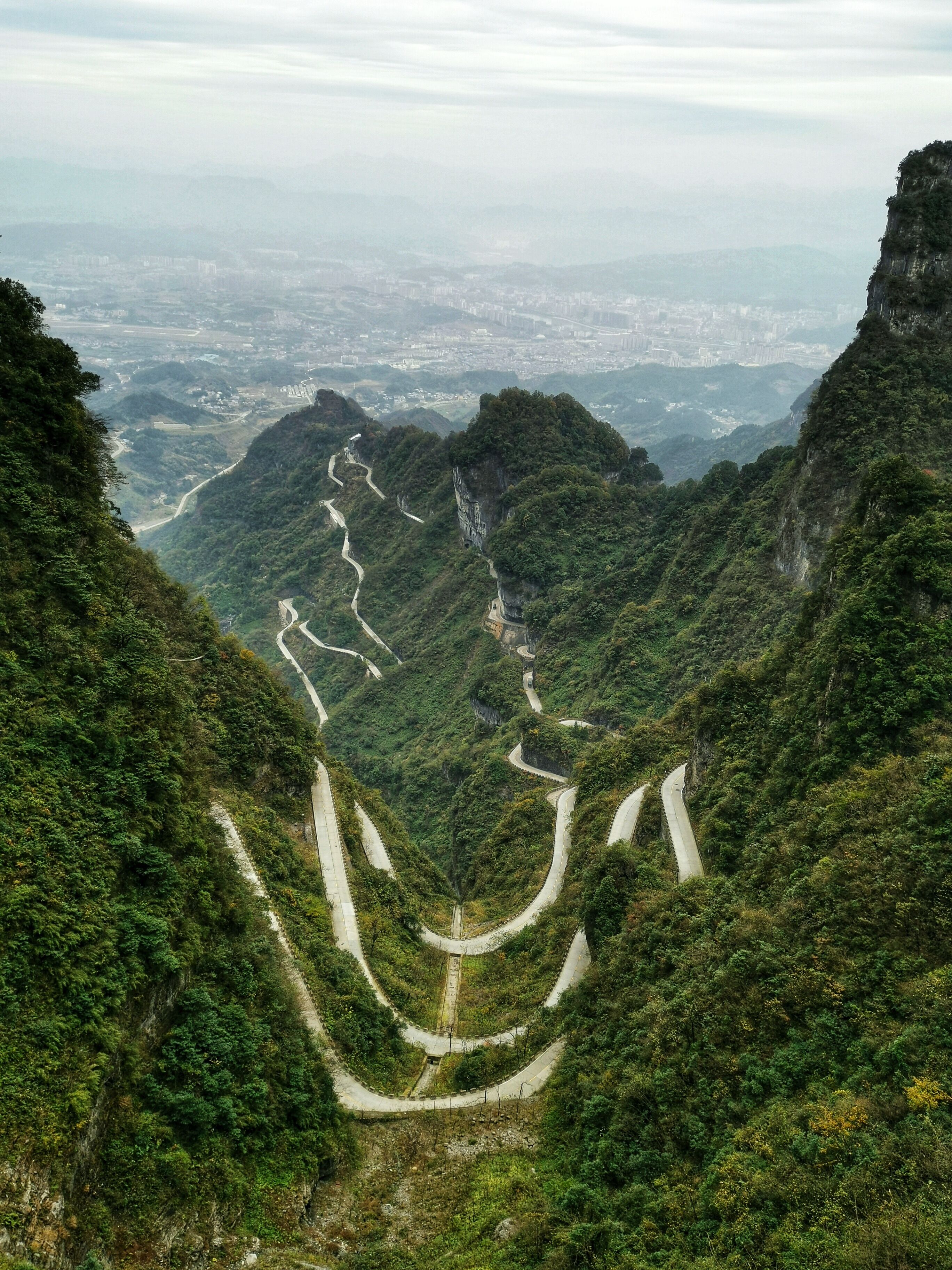 #trovember. As the cable car stopped working by the time we're there, it's the tourist bus carrying the tourists through this winding road all the way up to the lower escalator station of Tianmen Mountain. The view from the bus over what we had  travelled was just amazing.