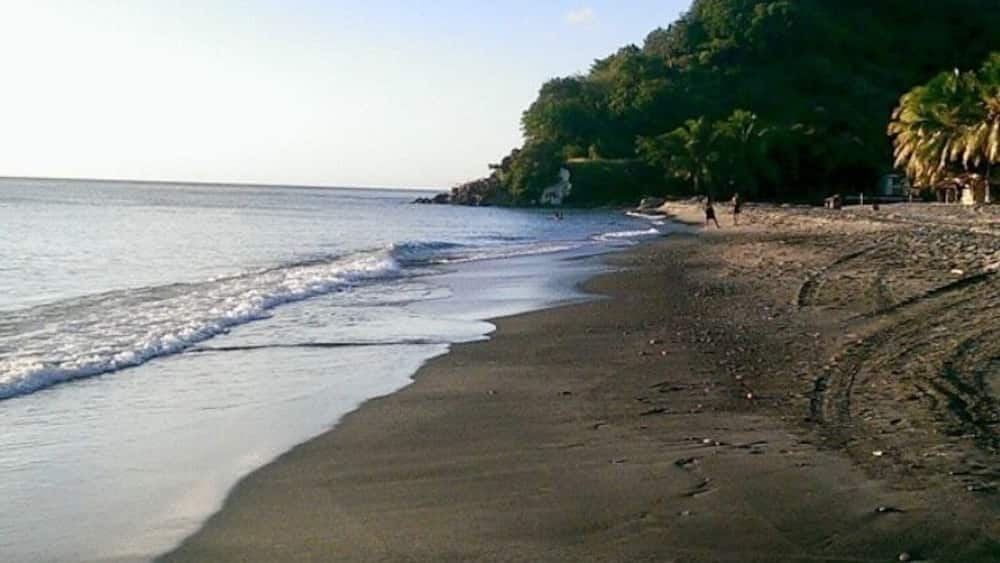 Beautiful black sand beach in Dominica the beach bar sells very fresh fried dolphin fish and bakes. Black sand feels so different from the white one it’s so soft and has bigger granules.
