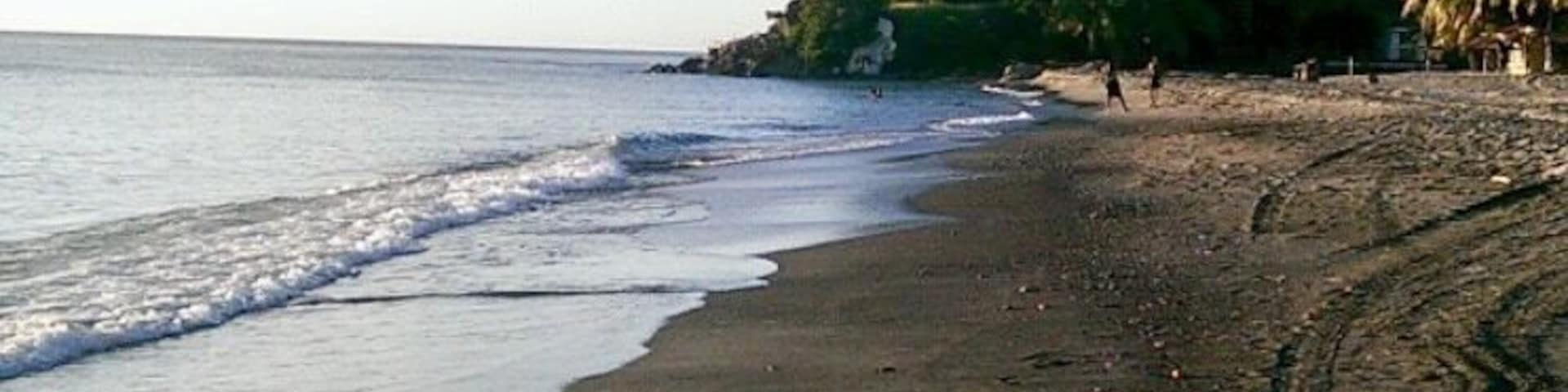 Beautiful black sand beach in Dominica the beach bar sells very fresh fried dolphin fish and bakes. Black sand feels so different from the white one it’s so soft and has bigger granules.