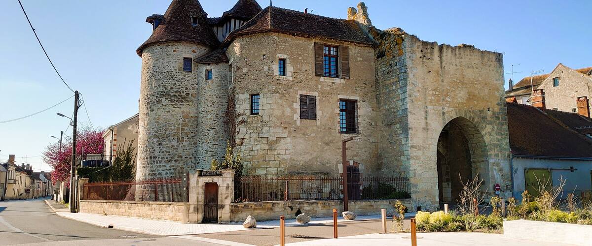 A historic stone castle with multiple towers and arched windows.