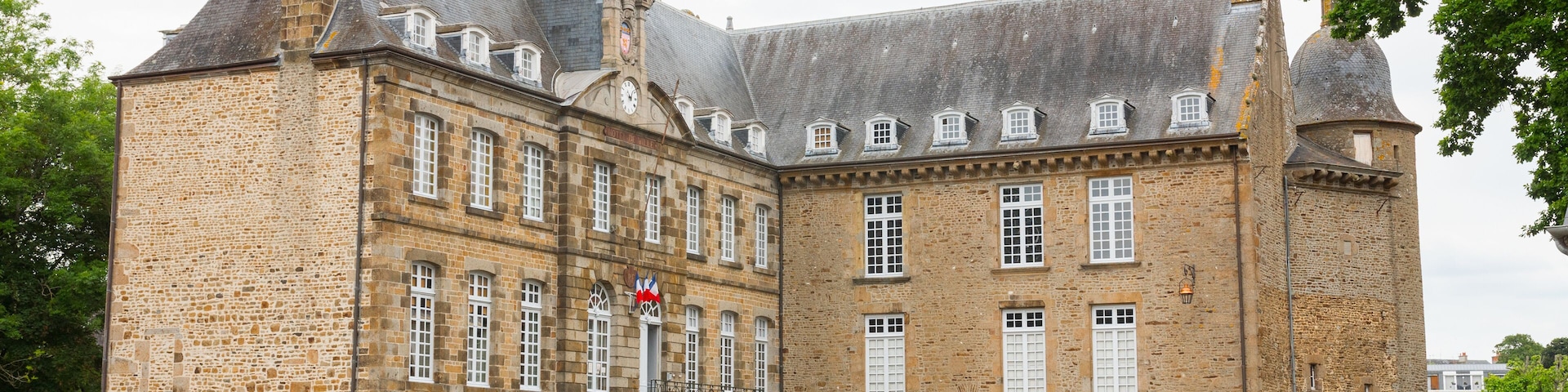 The castle of Flers, now a museum (Normandy, Orne, France). Beautiful medieval architecture. Wide-angle shot of this historical monument. Surrounded by a moat. Cloudy day.