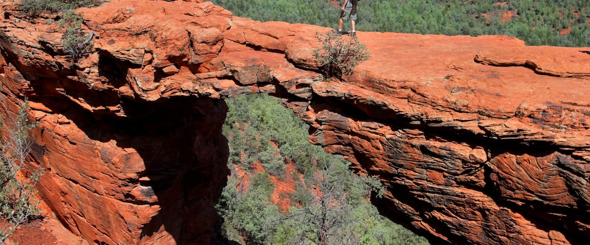 Man hiking at Devils Bridge in Sedona Arizona