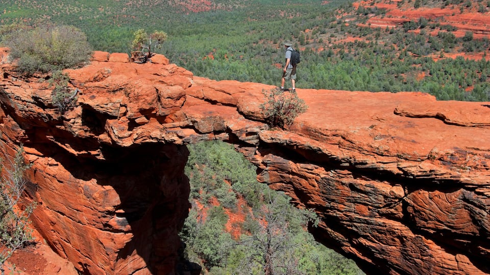 Man hiking at Devils Bridge in Sedona Arizona