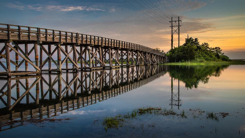 Placid sunrise next to a wooden trestle