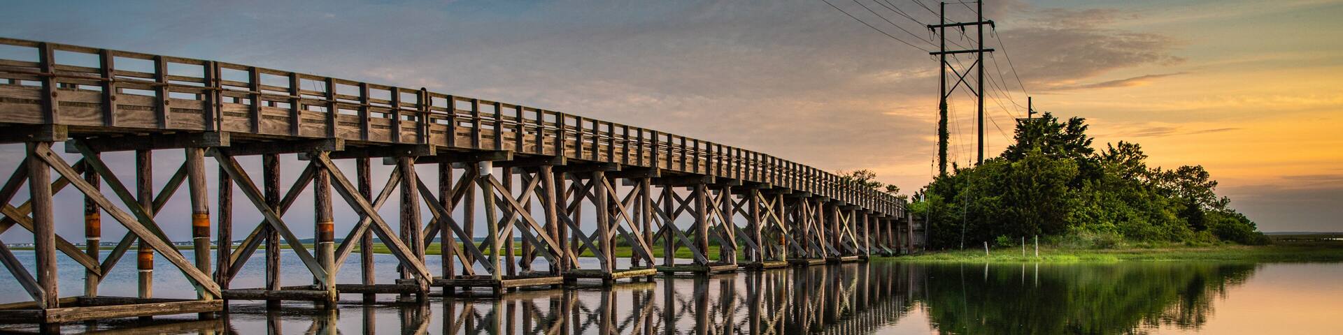 Placid sunrise next to a wooden trestle
