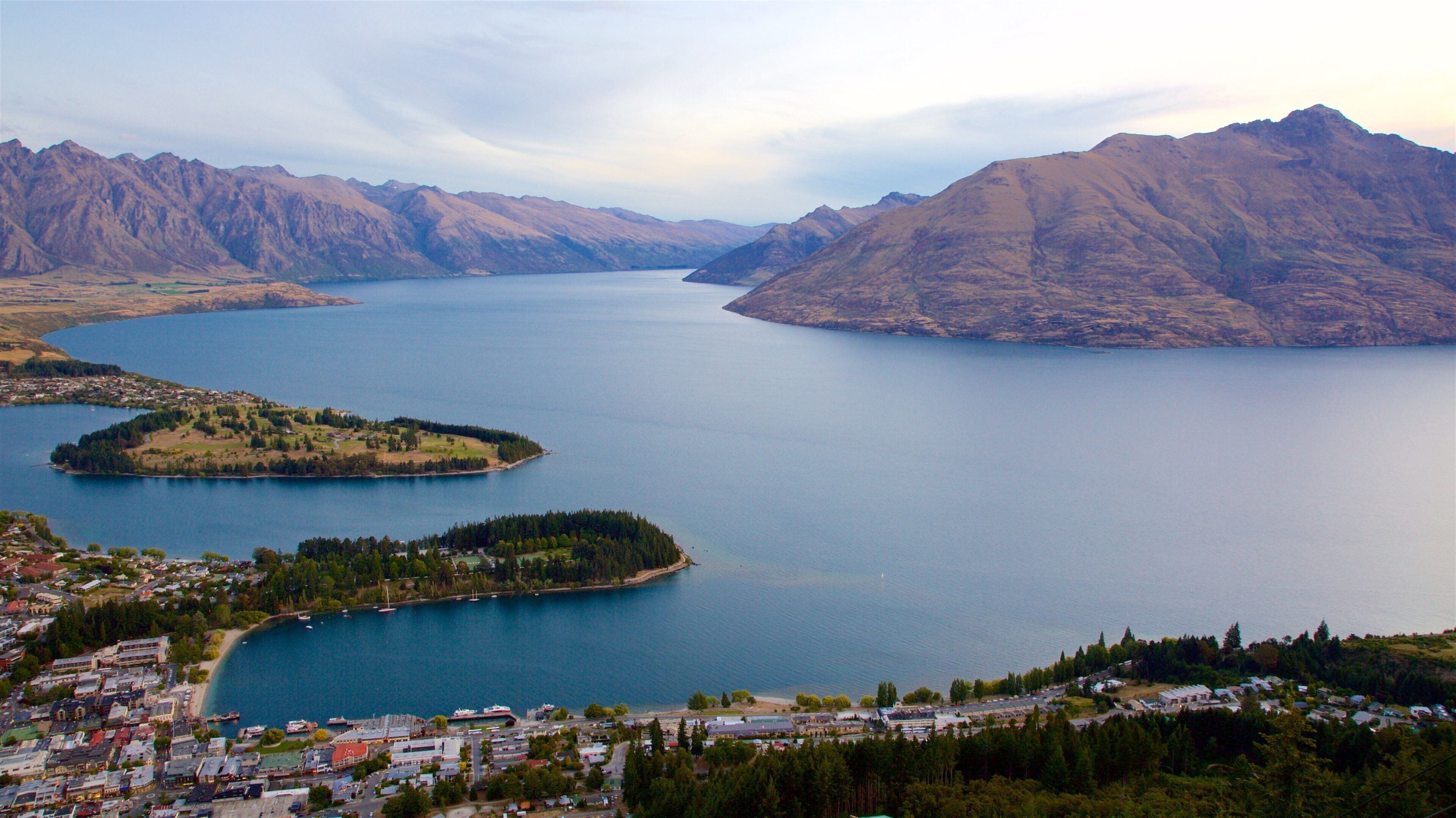 Cecil Peak featuring a small town or village, mountains and a sunset