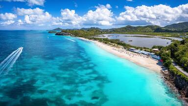 Panoramic aerial view of the beautiful Darkwood Beach at the Caribbean island of Antigua with turquoise sea and fine sand