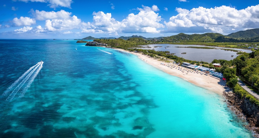 Panoramic aerial view of the beautiful Darkwood Beach at the Caribbean island of Antigua with turquoise sea and fine sand