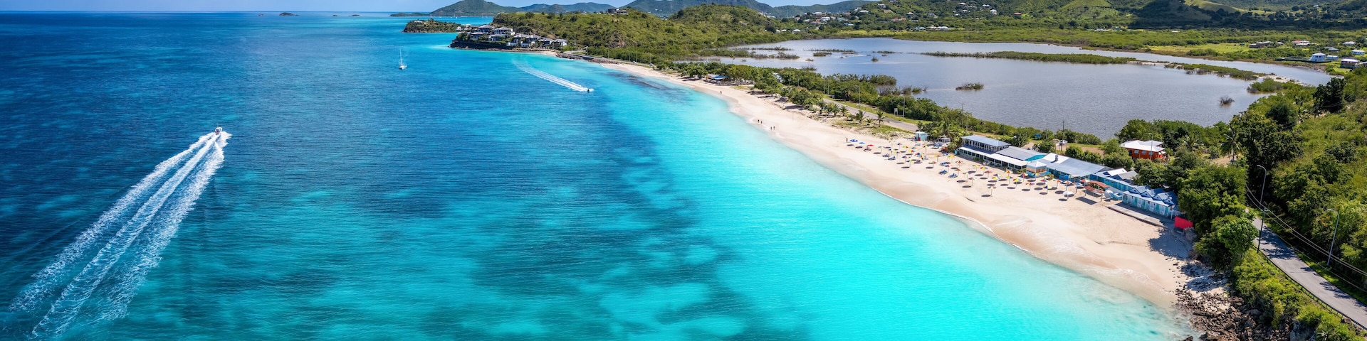 Panoramic aerial view of the beautiful Darkwood Beach at the Caribbean island of Antigua with turquoise sea and fine sand