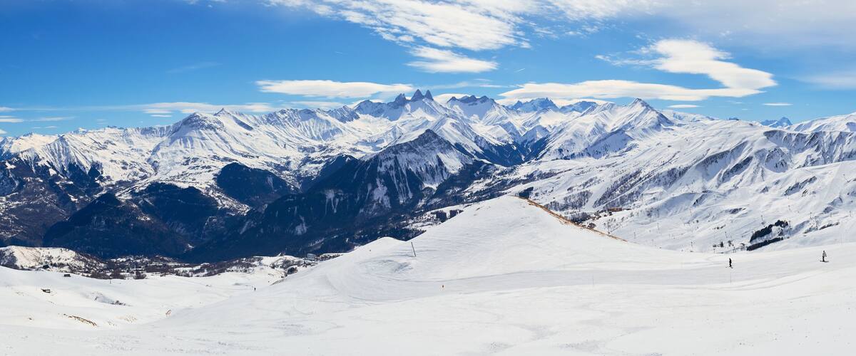 A snow-covered mountain range with clear skies.