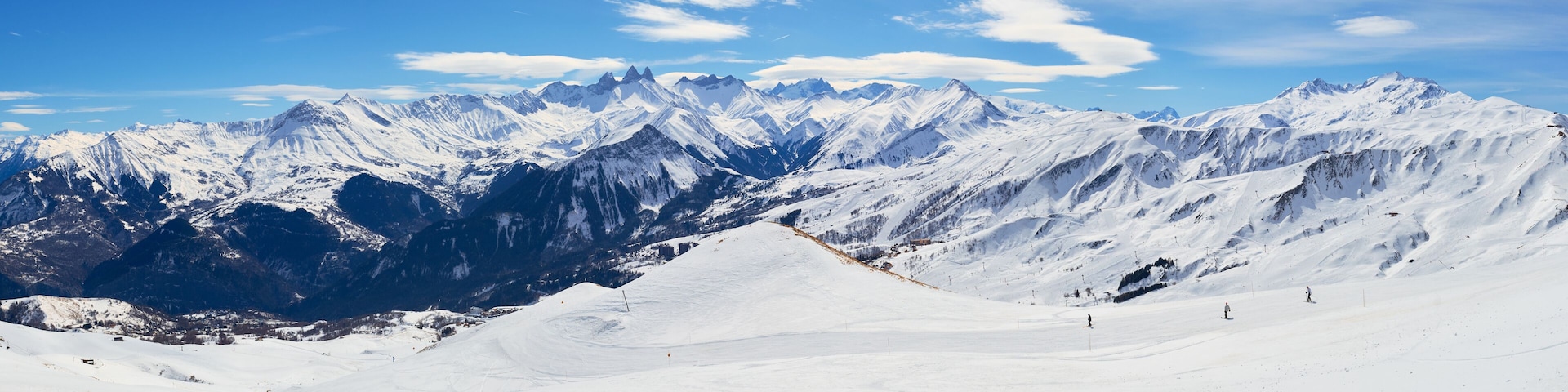 A snow-covered mountain range with clear skies.
