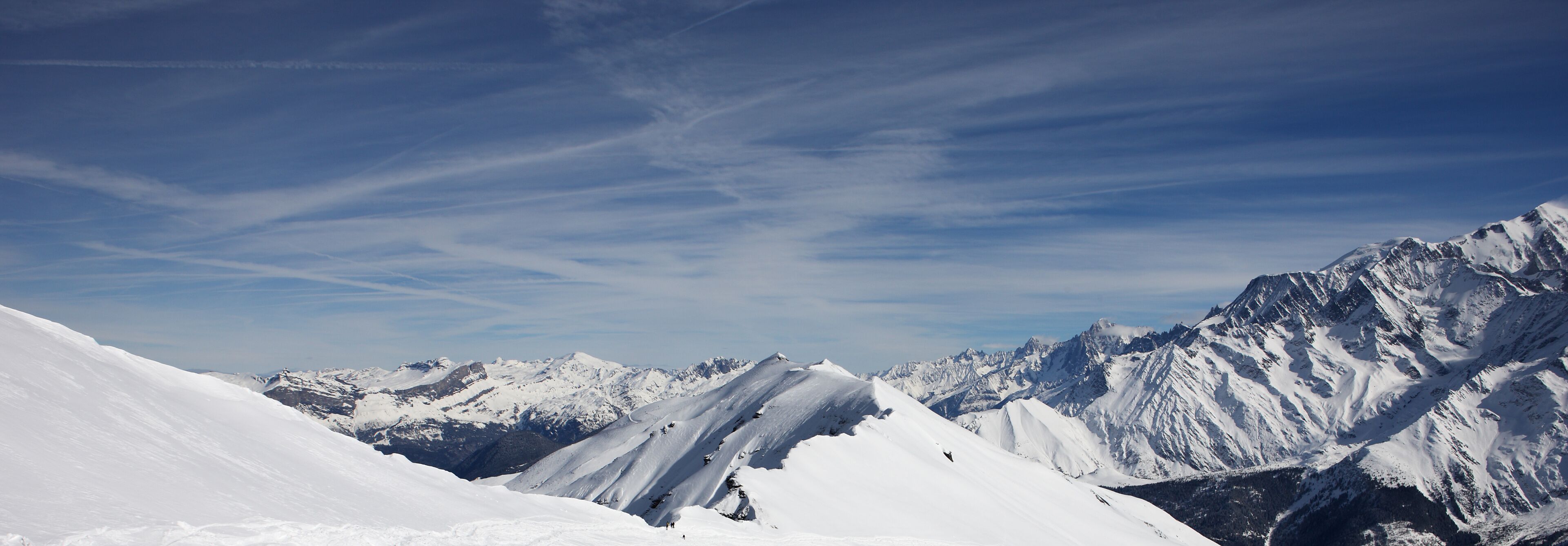 A snow-covered mountain range with clear skies.