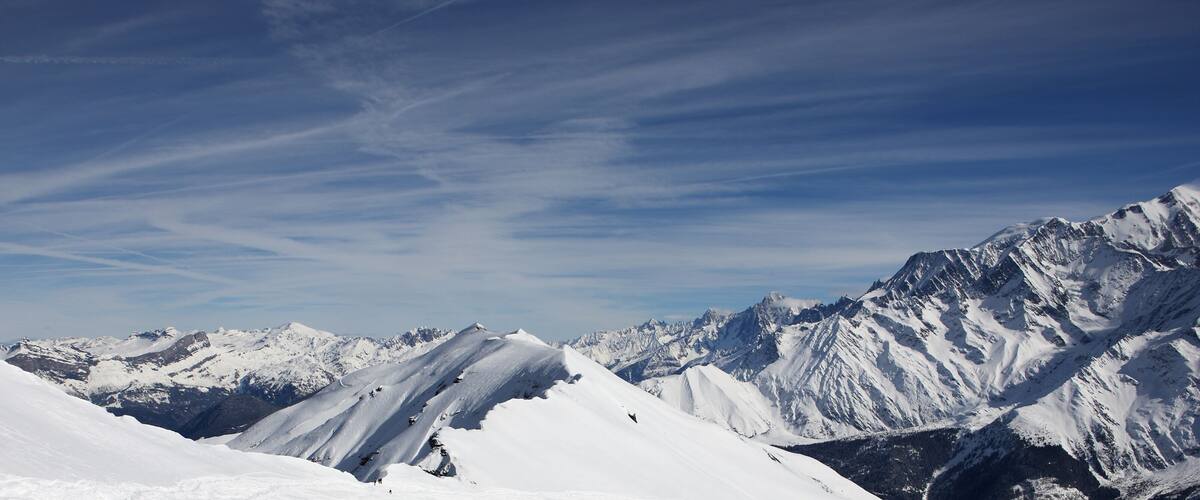 A snow-covered mountain range with clear skies.