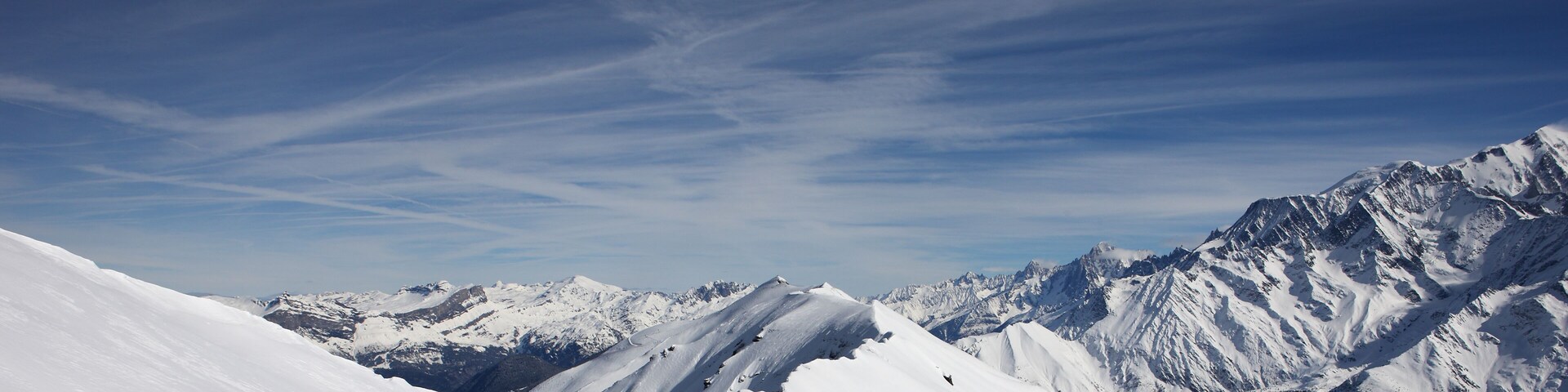 A snow-covered mountain range with clear skies.