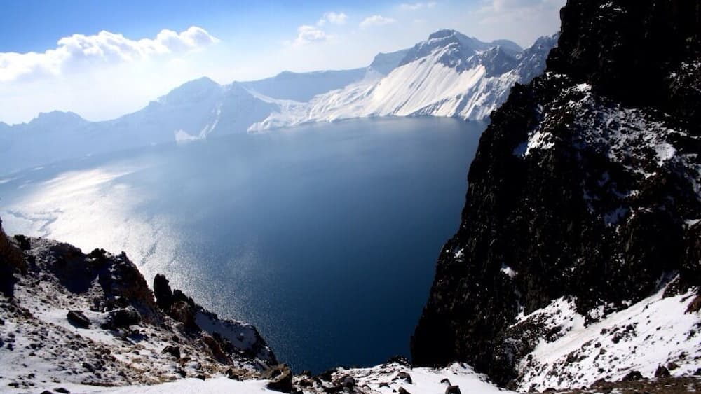 Heavenly lake: A deep blue Volcanic crater lake at an elevation of 2104m is the highlight of Changbaishan. The lake,12kms in circumference is surrounded by jagged rick out crops and 15mountainous peaks the highest is White Rock Peak(baiyan feng) 2794m.
