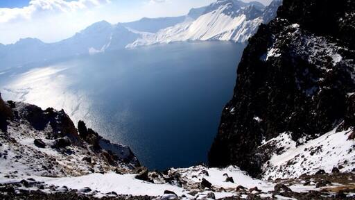 Heavenly lake: A deep blue Volcanic crater lake at an elevation of 2104m is the highlight of Changbaishan. The lake,12kms in circumference is surrounded by jagged rick out crops and 15mountainous peaks the highest is White Rock Peak(baiyan feng) 2794m.