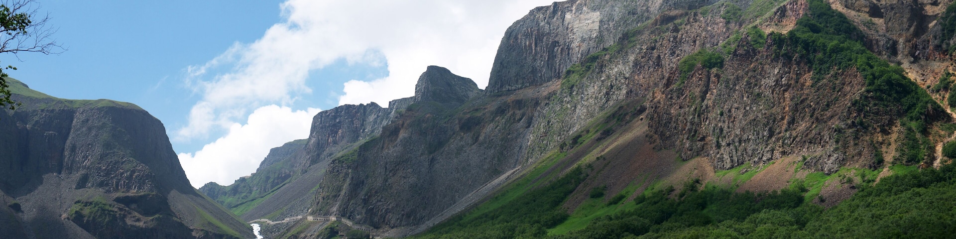 A mountainous landscape with a river flowing through a valley.