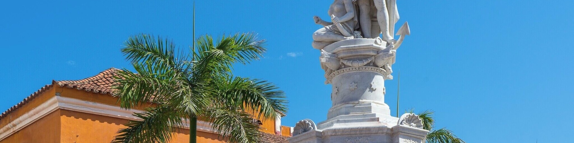 A statue of Christopher Columbus stands at the edge of Plaza de la Aduana, the largest and oldest square in the Old City of Cartagena. Colombia is named after Christopher Columbus, even though he never set foot on Colombian soil.