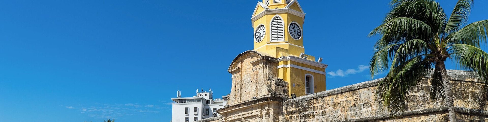 The Clock Tower, or "Torre de Reloj", is the main city gate of the historic center of Cartagena. Originally known as Boca del Puente (The Mouth of the Bridge), this entrance to the fortified city once utilized a drawbridge to cross the surrounding moat.
A pendulum clock was added in 1871, and replaced with a more superior Swiss clock in 1934 which is still in operation to the present day.