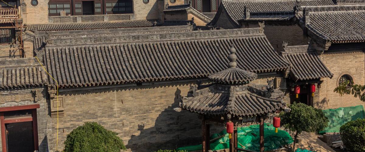 Traditional Chinese architecture with tiled roofs and ornate details.