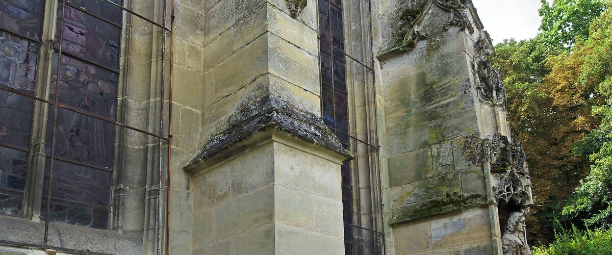 A historic stone building with arched windows and intricate carvings.
