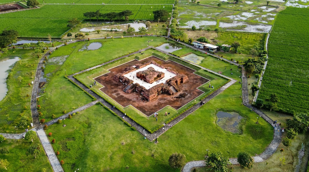 Aerial drone view of Blandongan temple at Karawang and surrounded by green grass with noise cloud. Karawang, Indonesia. March 21, 2021