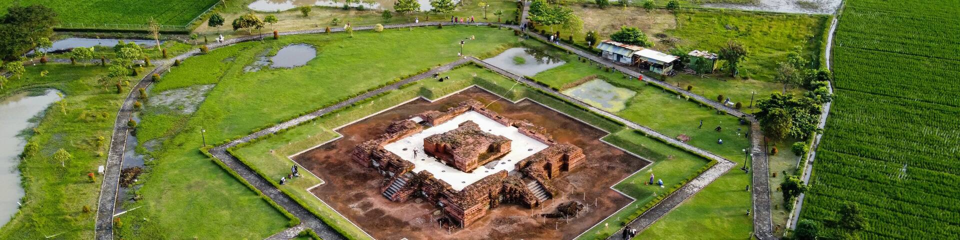 Aerial drone view of Blandongan temple at Karawang and surrounded by green grass with noise cloud. Karawang, Indonesia. March 21, 2021
