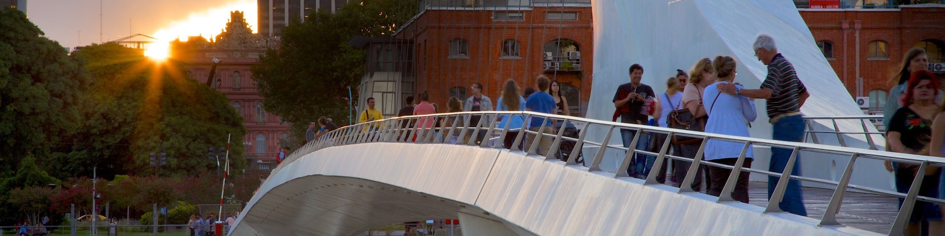 Puerto Madero which includes a sunset, a bridge and modern architecture