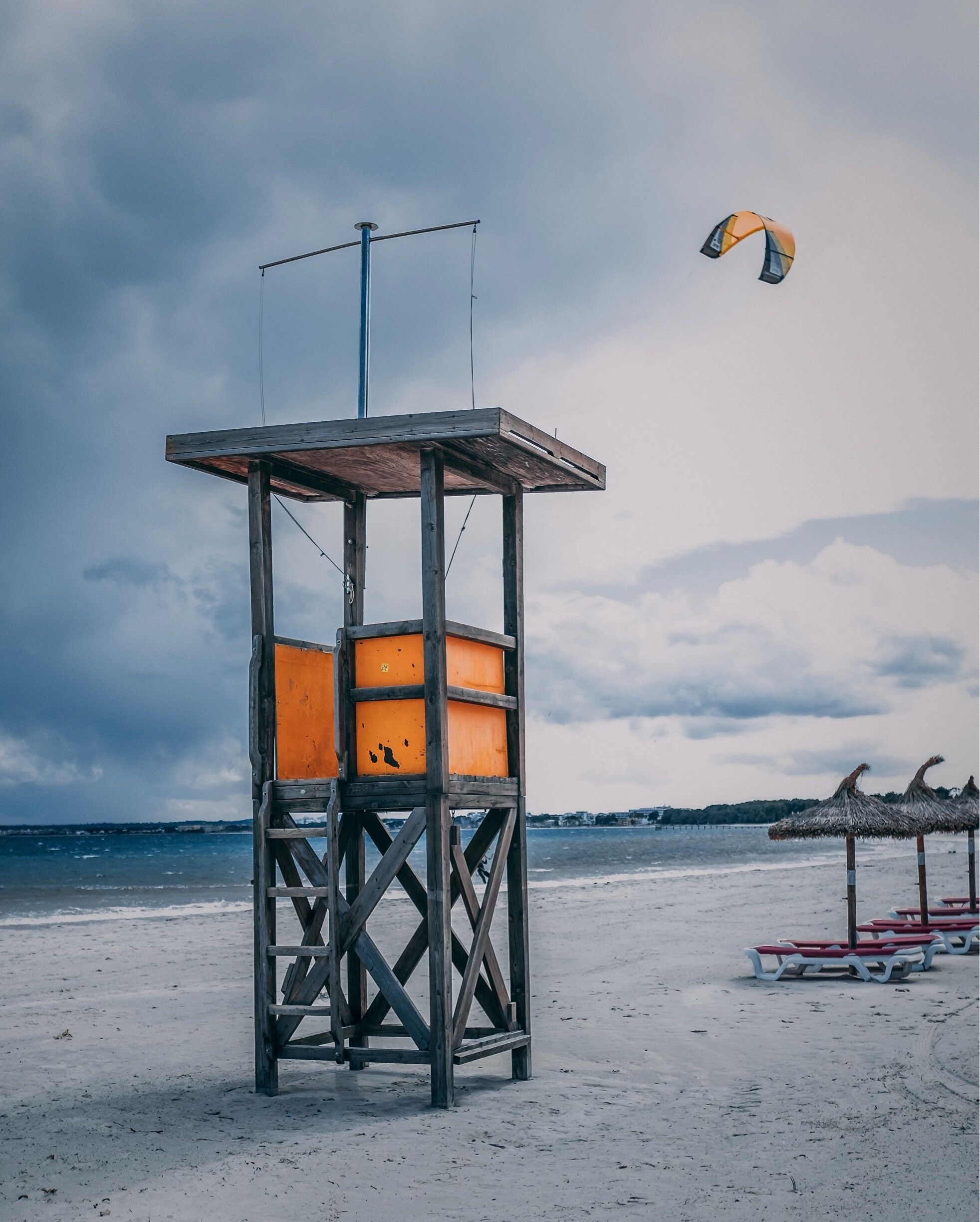 Empty lifeguard tower being buzzed by Kitesurfer’s in the bay.
strong winds along this beach makes it very popular place to go Kitesurfing in Alcúdia.  
