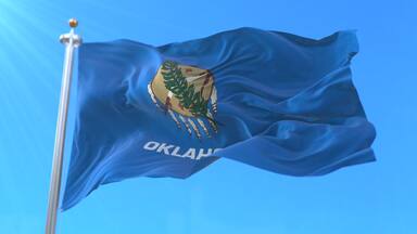 Flag of american state of Oklahoma, region of the United States, waving at wind