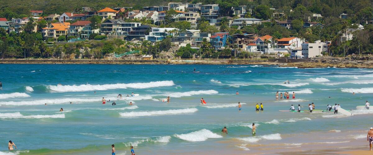 Manly Beach showing a beach, a coastal town and swimming