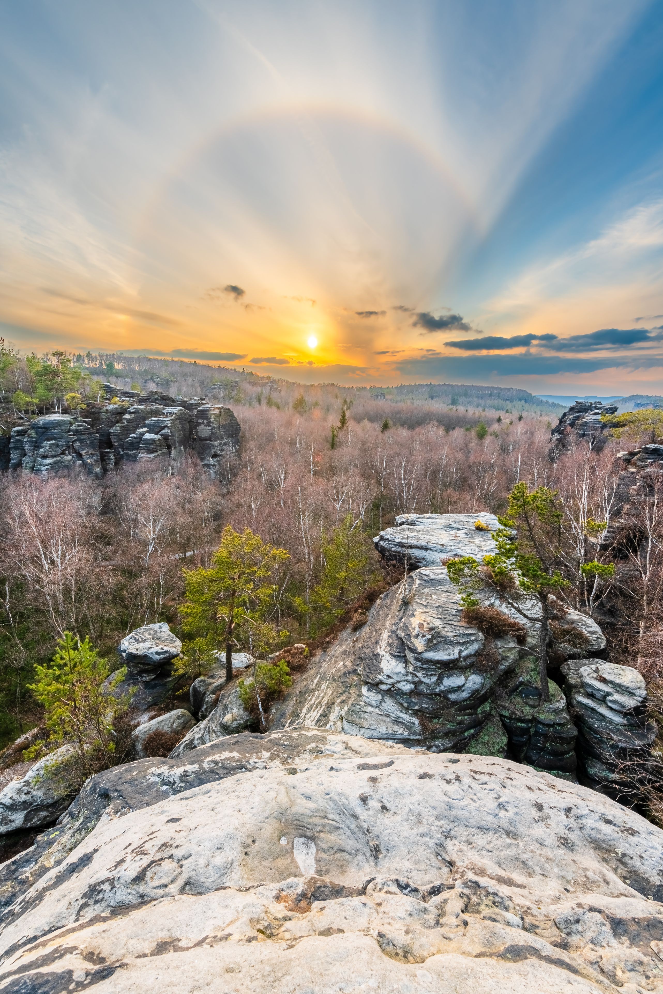 A rocky landscape with a sunset in the background.