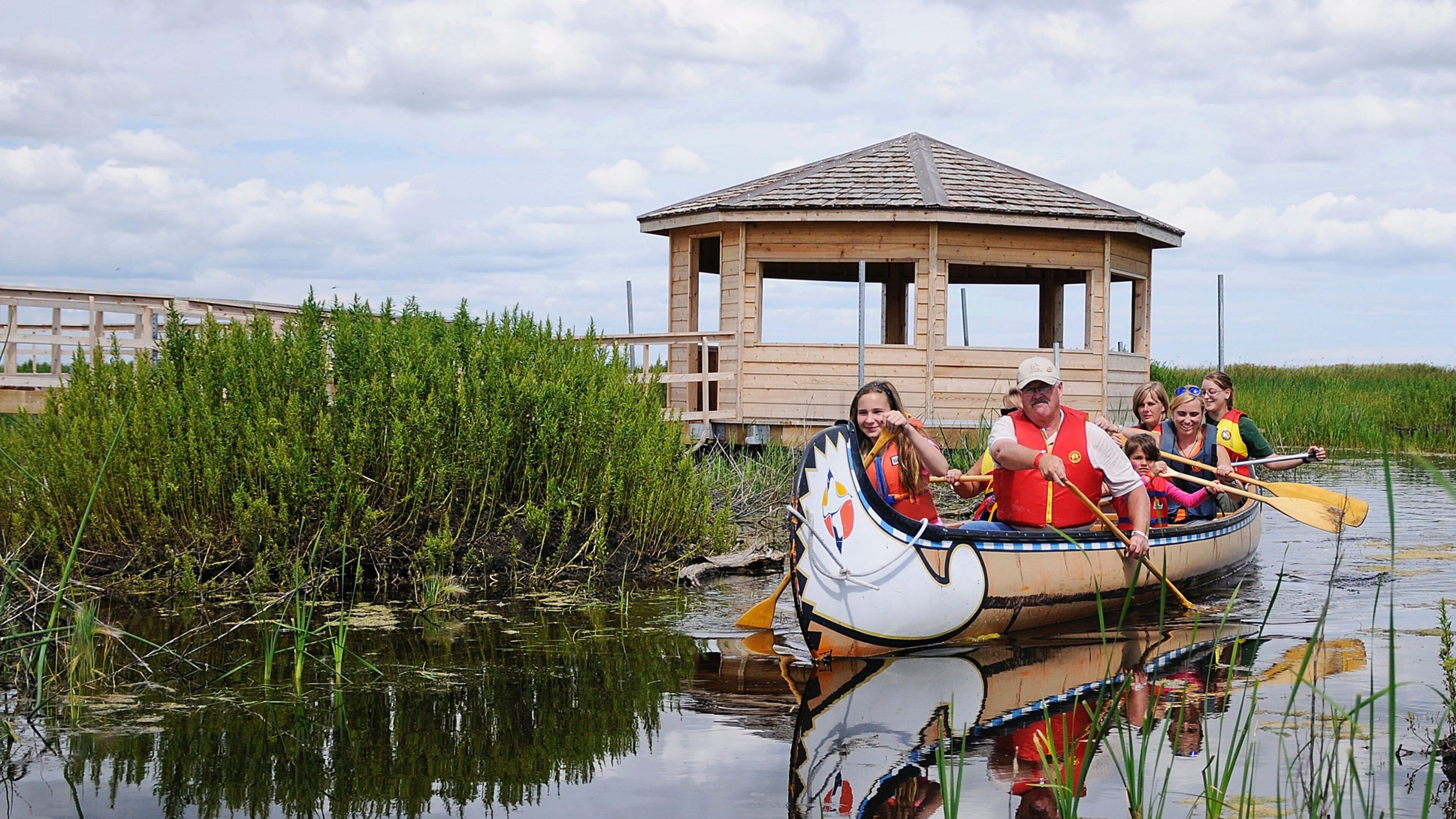 Winnipeg showing kayaking or canoeing and wetlands as well as a family
