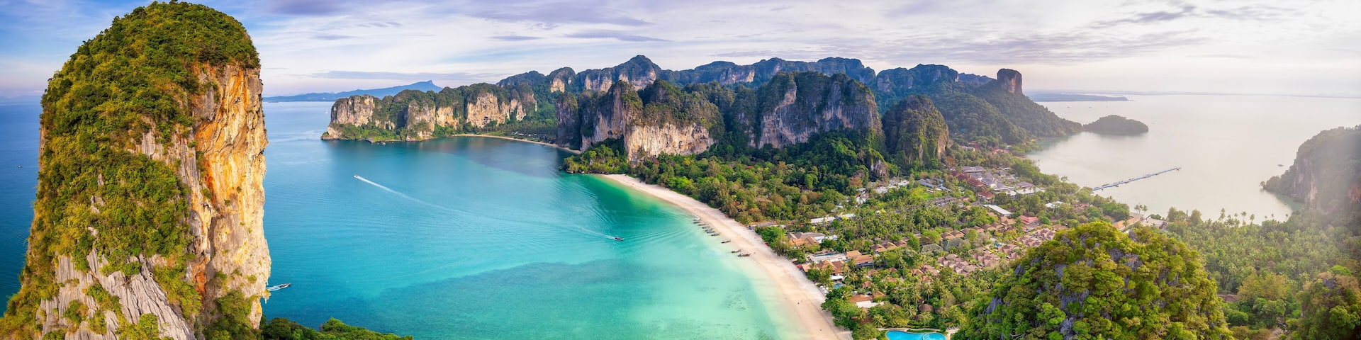Panoramic aerial sunrise view of the beautiful Railay beach, Krabi, Thailand, lush rain forest and emerald sea