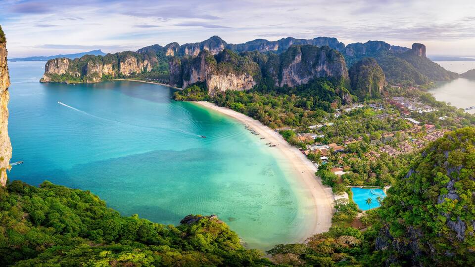 Panoramic aerial sunrise view of the beautiful Railay beach, Krabi, Thailand, lush rain forest and emerald sea