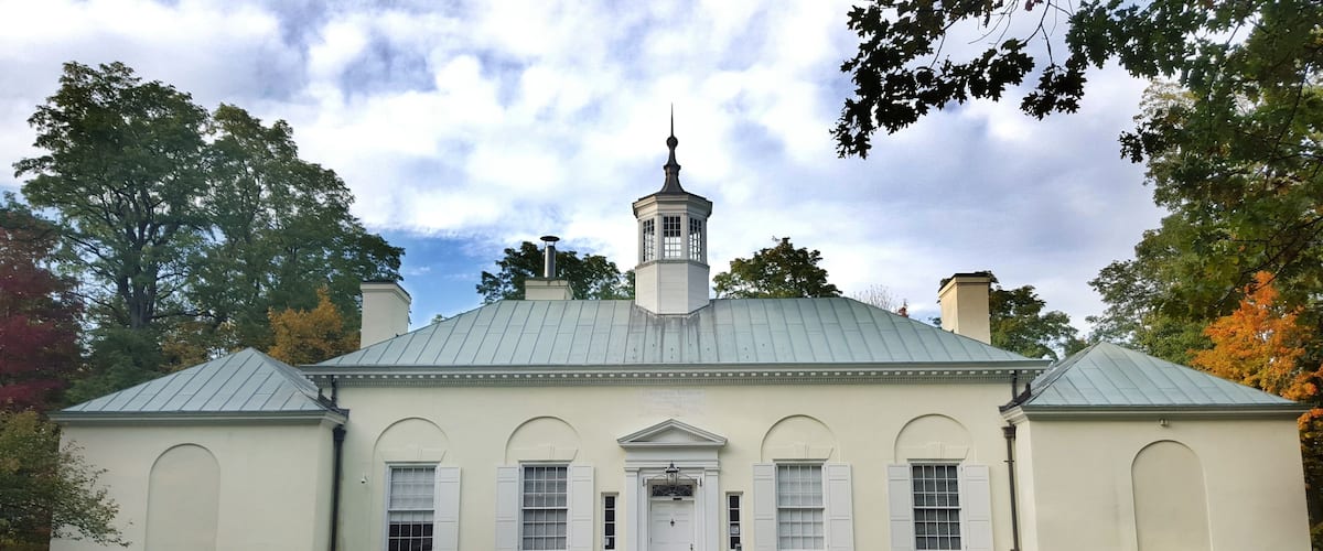 A historic building with a central tower, arched windows, and a symmetrical facade.