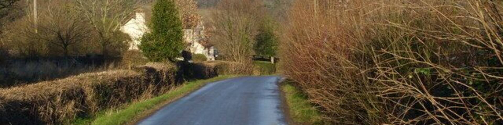 The view down Glasshouse Hill. With the Malverns breaking through the mist in the far distance.
