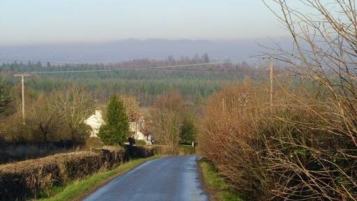 The view down Glasshouse Hill. With the Malverns breaking through the mist in the far distance.