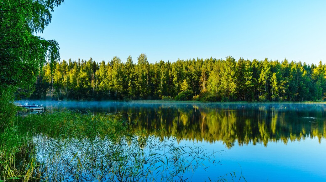 Beaitiful landscape of Lake Haukivesi during sunrise. Light fog over the water. Specular reflection in the water. Saimaa lake system, Rantasalmi, Savo, Finland.