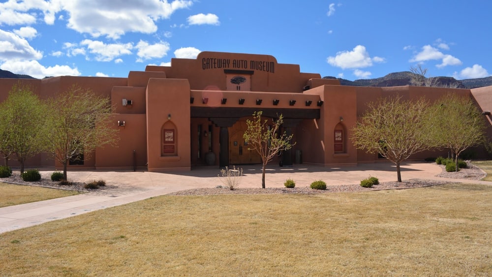The Gateway Auto Museum with a clear blue sky and mountains in the background.