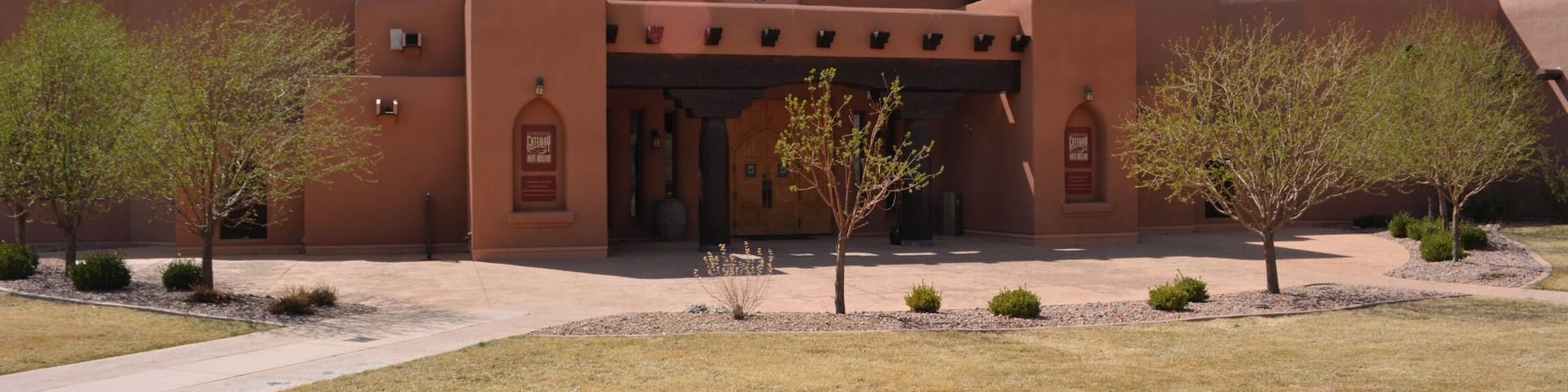 The Gateway Auto Museum with a clear blue sky and mountains in the background.